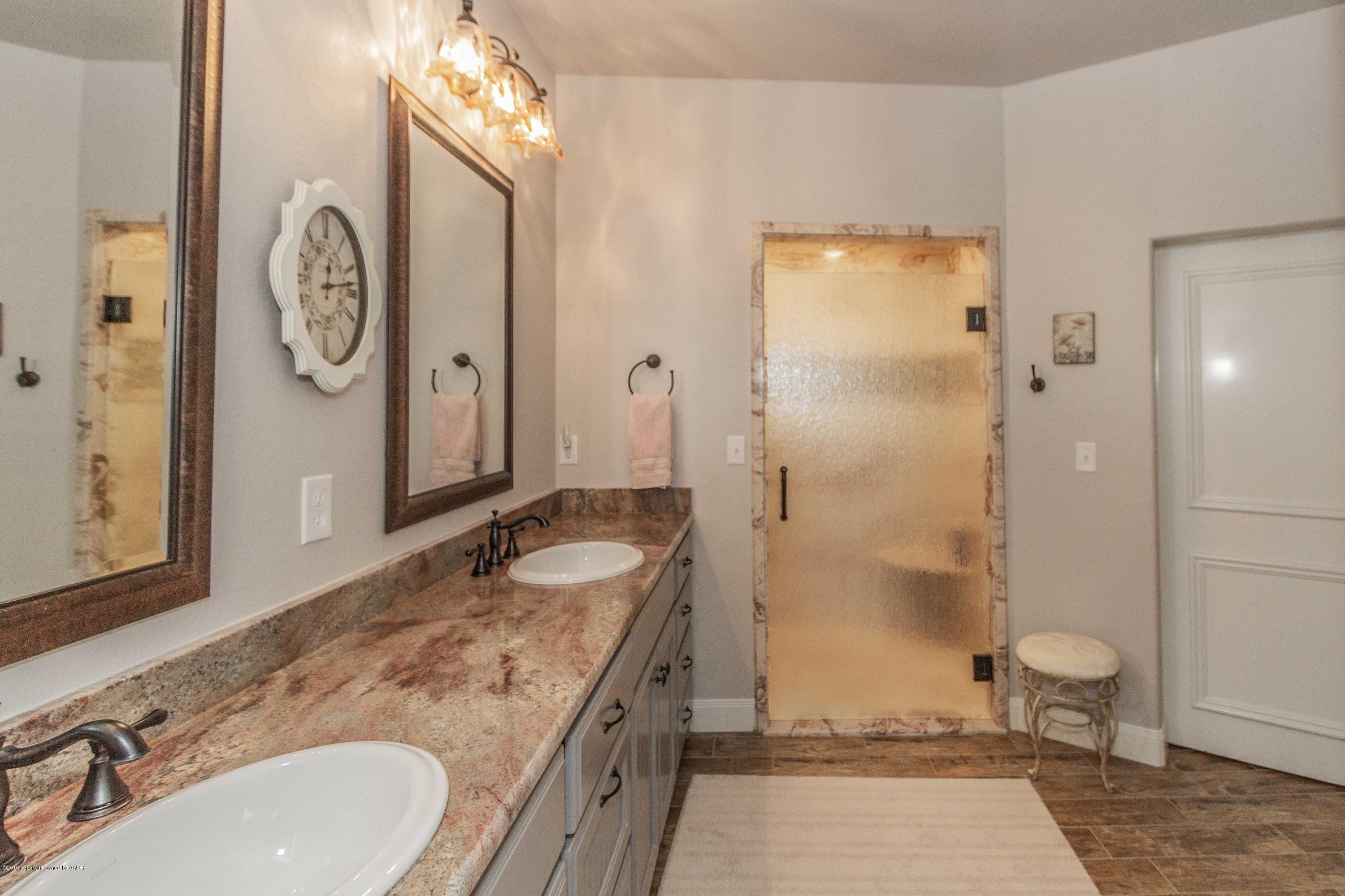 305 Mourning Dove Road Canyon, TX 79015 - Photo 31 of 65 a bathroom with a granite countertop sink and a mirror