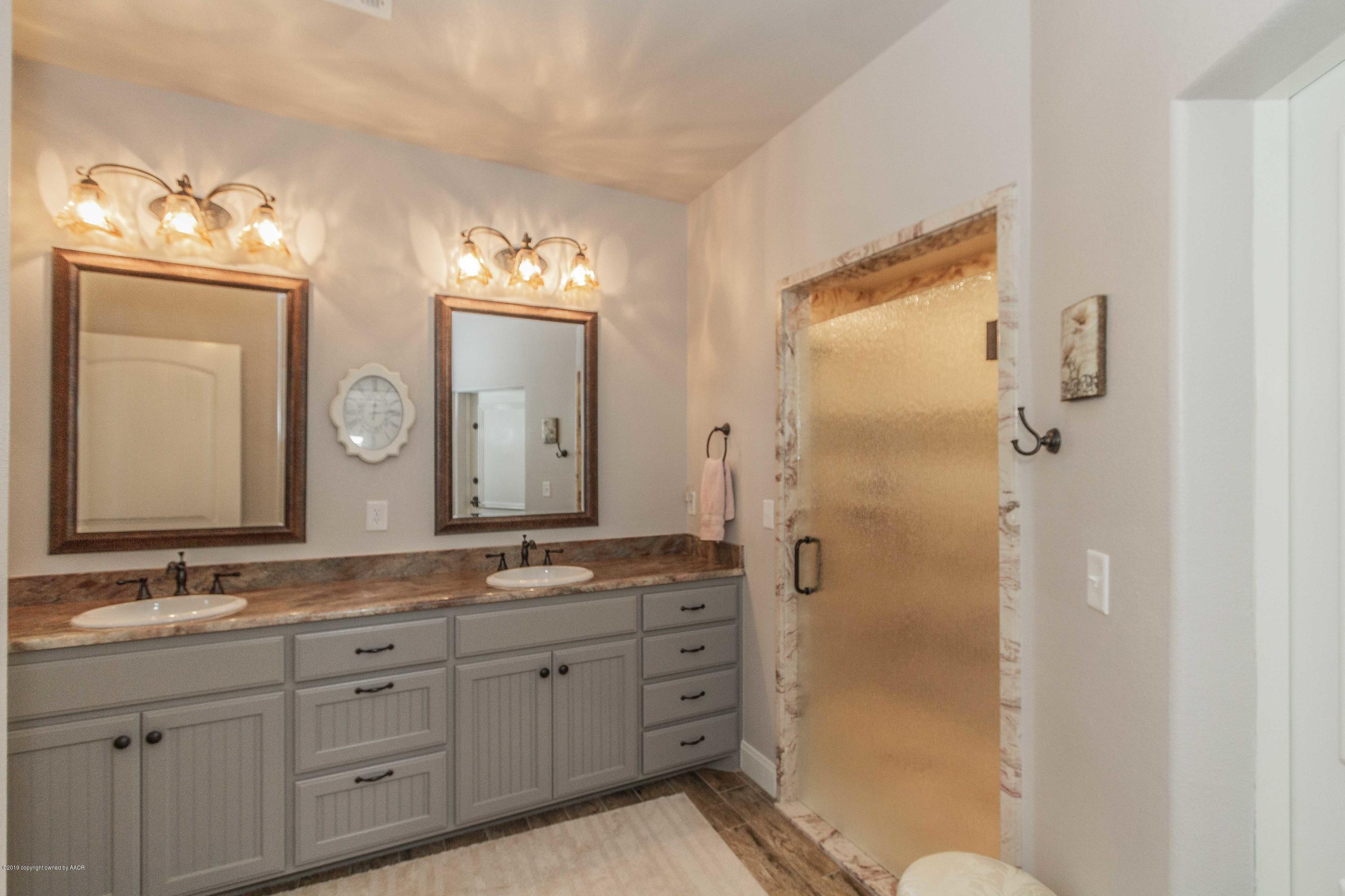 305 Mourning Dove Road Canyon, TX 79015 - Photo 33 of 65 a spacious bathroom with a granite countertop sink mirror and shower