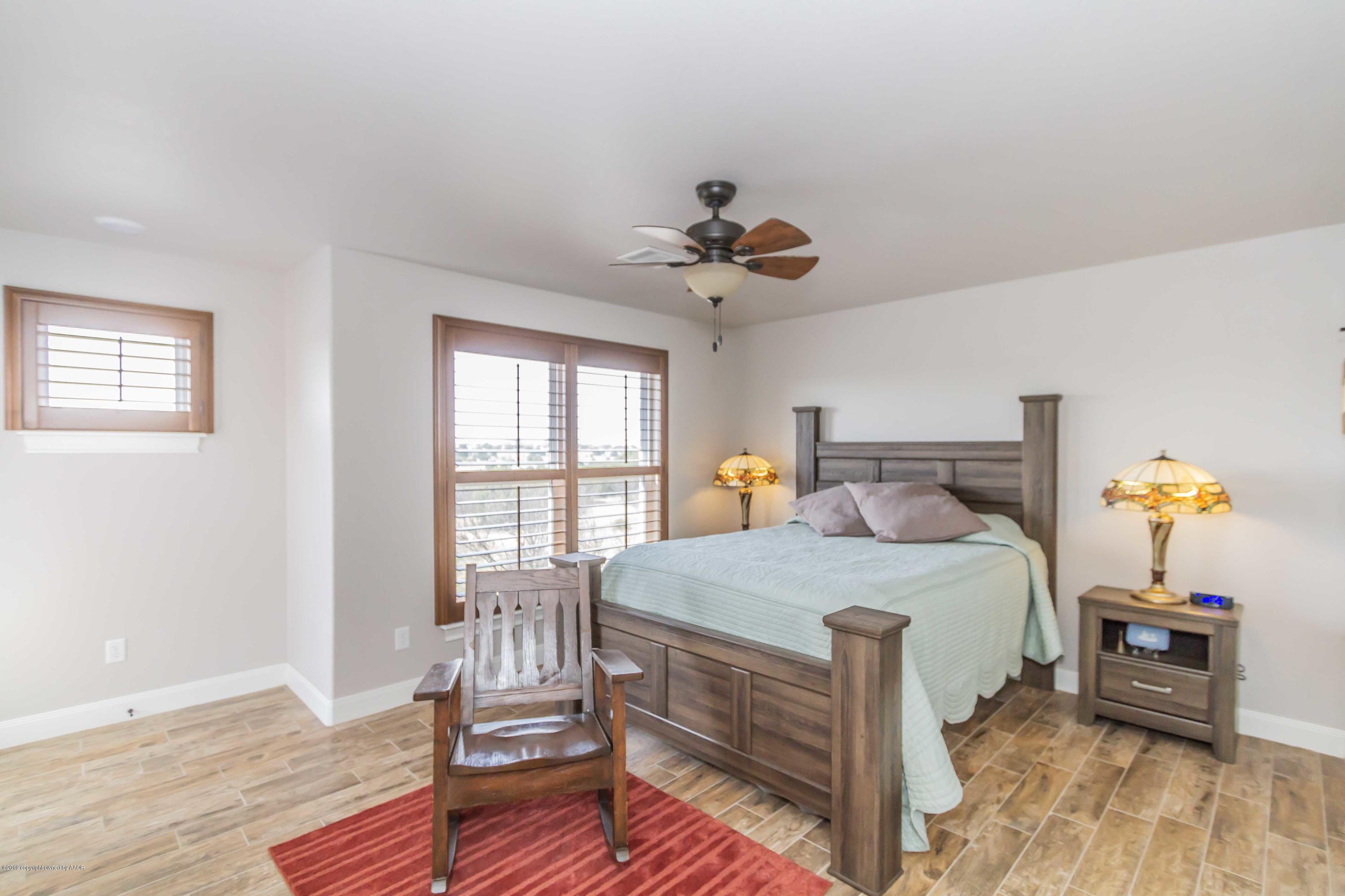 305 Mourning Dove Road Canyon, TX 79015 - Photo 36 of 65 a bedroom with a bed and wooden floor