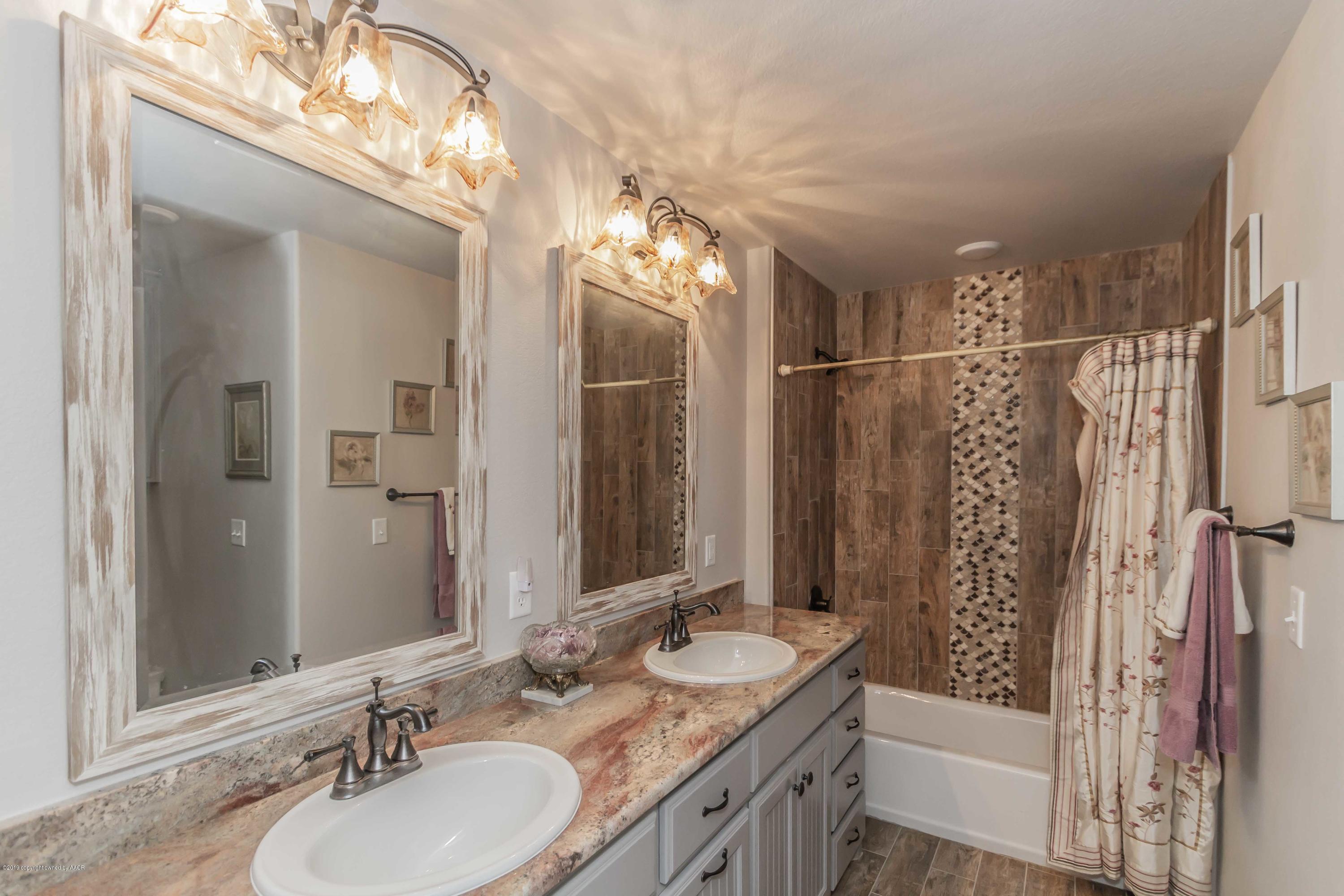 305 Mourning Dove Road Canyon, TX 79015 - Photo 39 of 65 a bathroom with a double vanity sink and a mirror