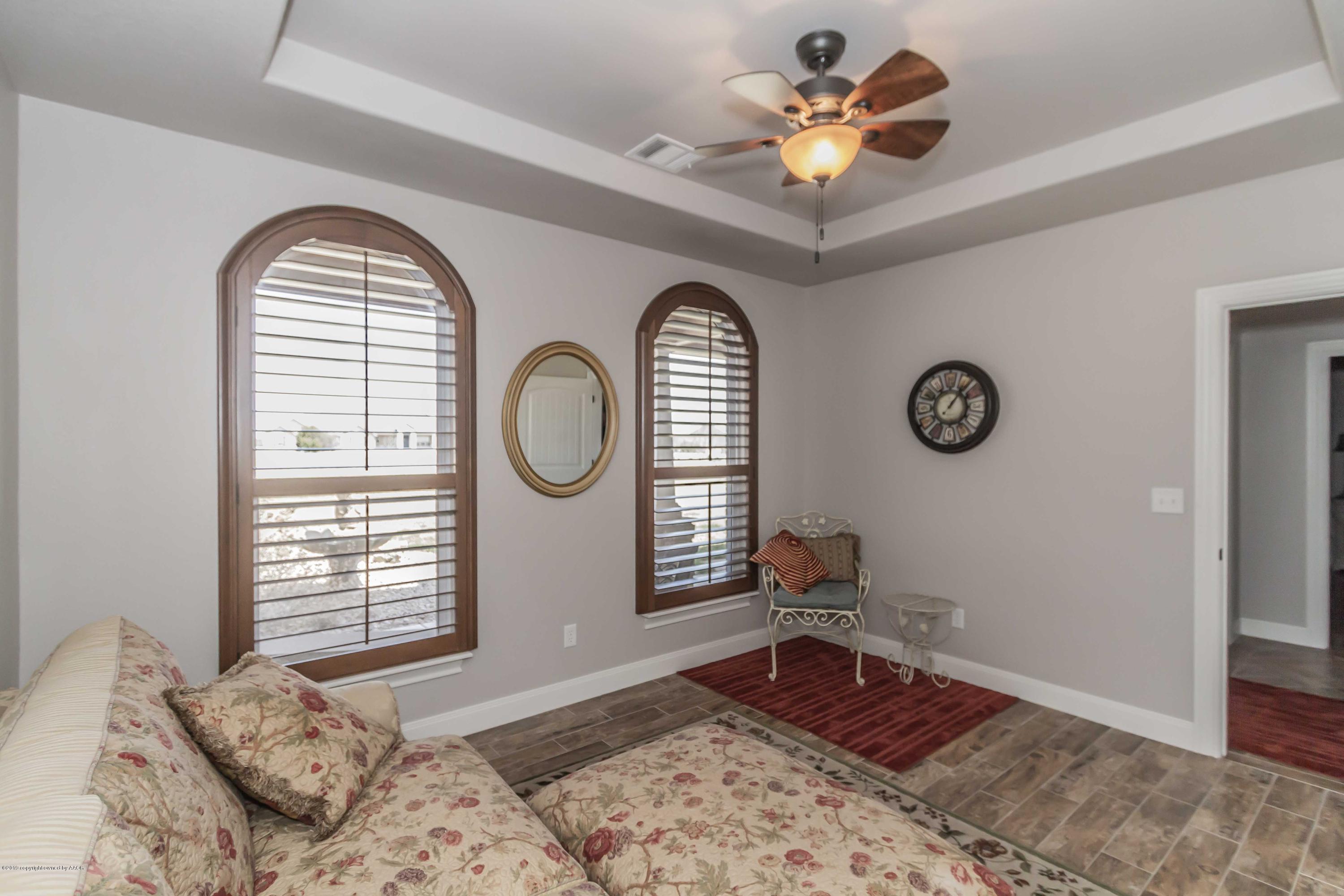 305 Mourning Dove Road Canyon, TX 79015 - Photo 48 of 65 a bedroom with a bed and a chandelier