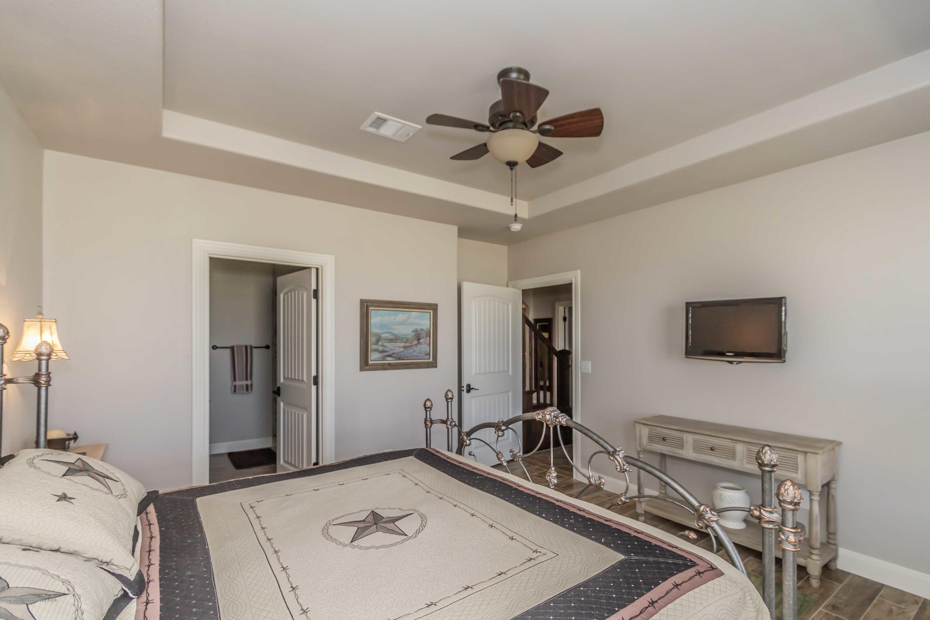 305 Mourning Dove Road Canyon, TX 79015 - Photo 53 of 65 a bedroom with a bed and a flat screen tv