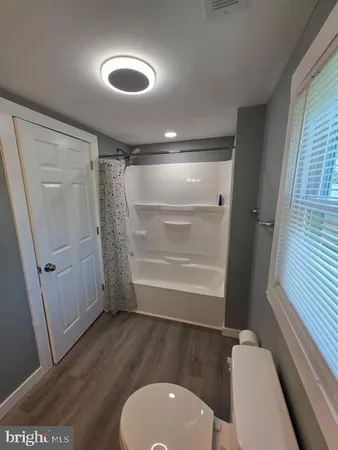 a bathroom with a toilet a sink and shower