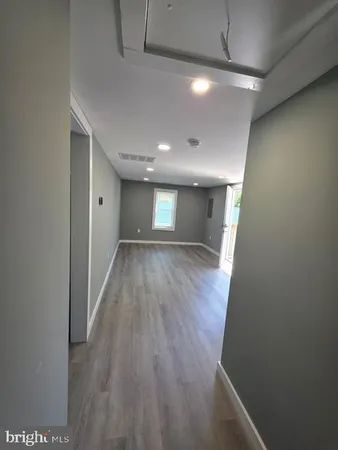 a view of hallway with wooden floor