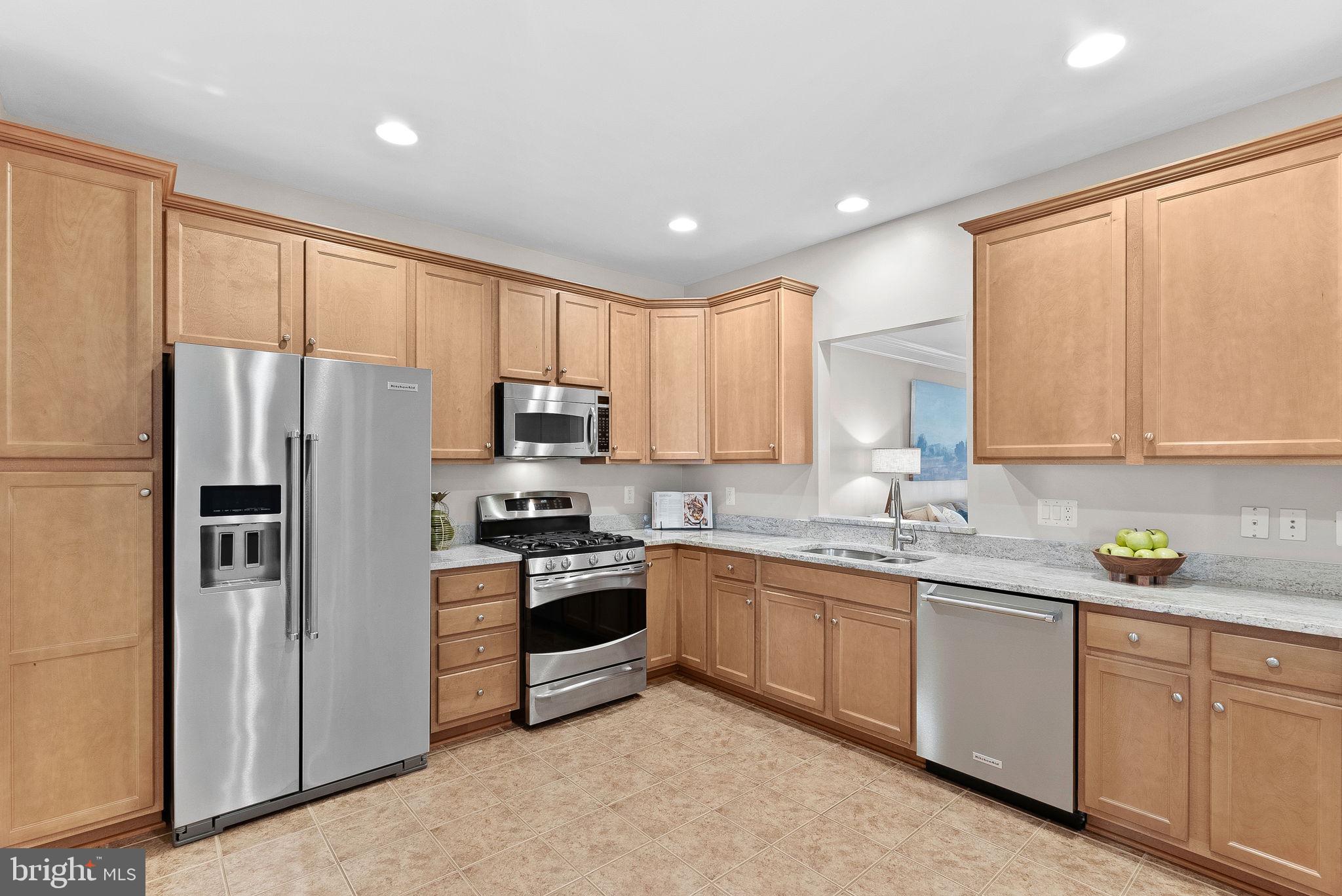 44424 Sunset Maple Drive Ashburn, VA 20147 - Photo 12 of 63 a kitchen with stainless steel appliances granite countertop a refrigerator sink and cabinets