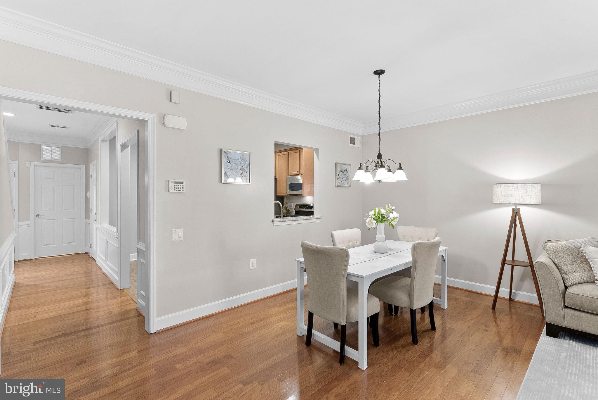 44424 Sunset Maple Drive Ashburn, VA 20147 - Photo 15 of 63 a view of a dining room with furniture wooden floor and chandelier