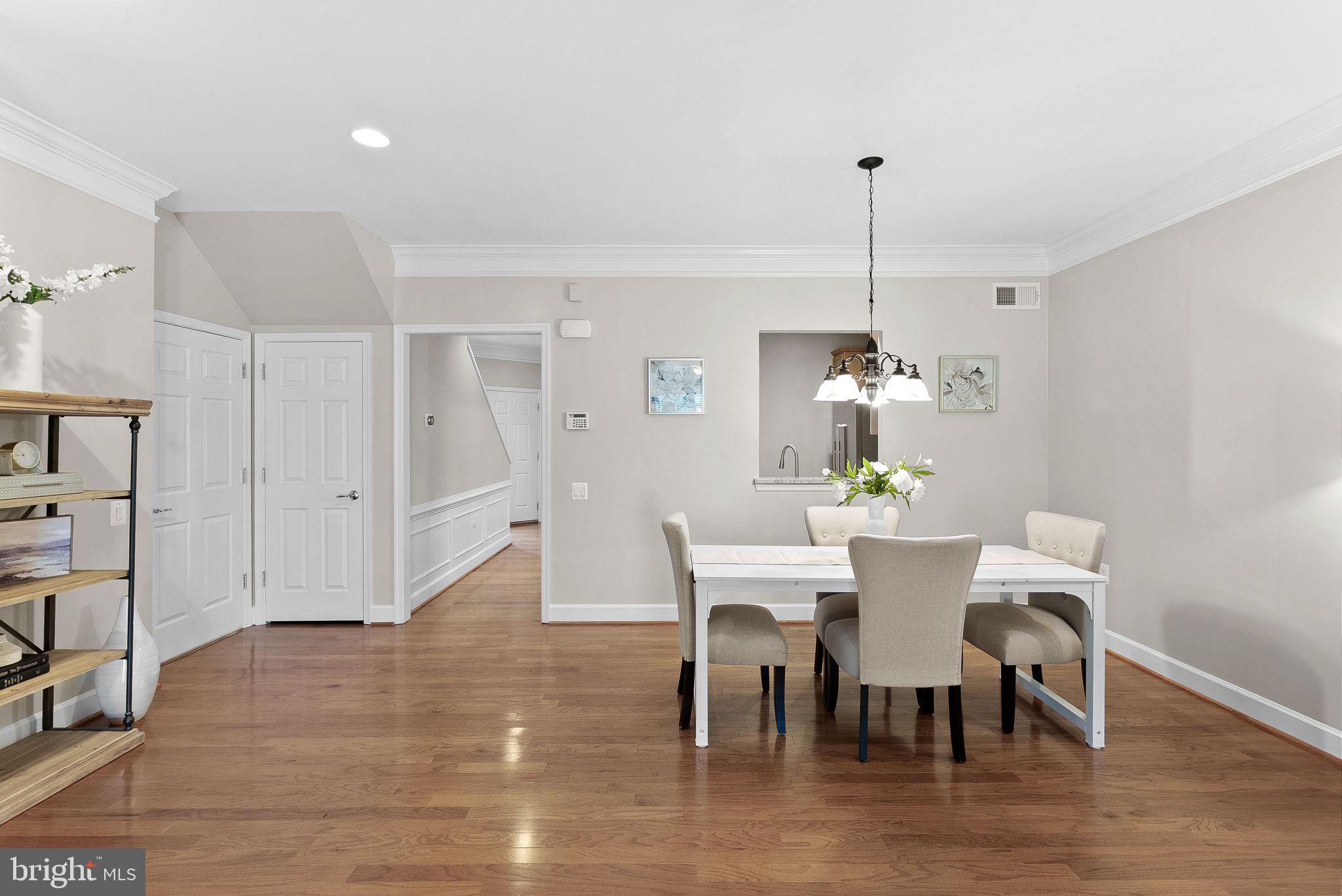 44424 Sunset Maple Drive Ashburn, VA 20147 - Photo 16 of 63 a view of a dining room with furniture wooden floor and chandelier
