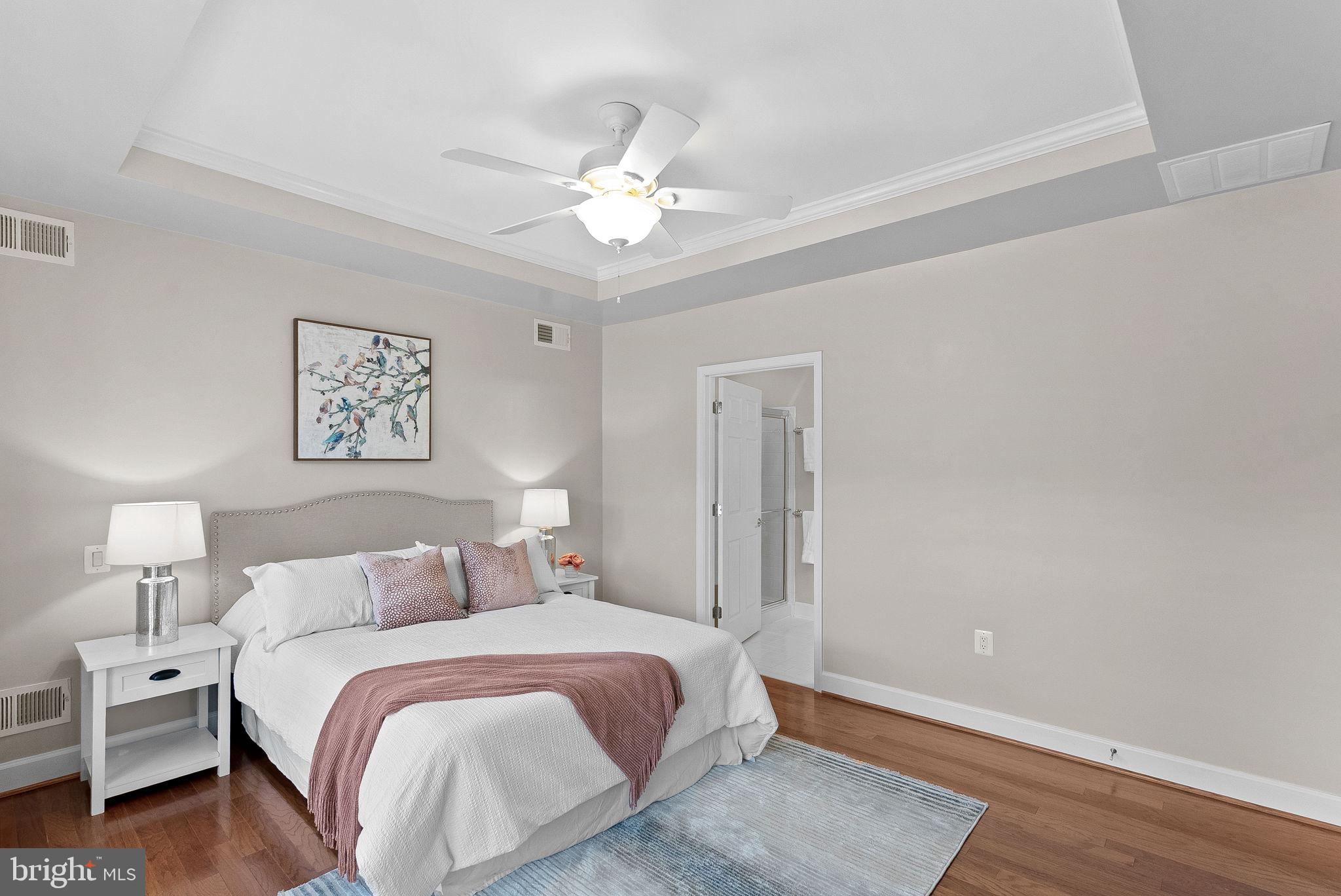44424 Sunset Maple Drive Ashburn, VA 20147 - Photo 27 of 63 a bedroom with a bed and a chandelier