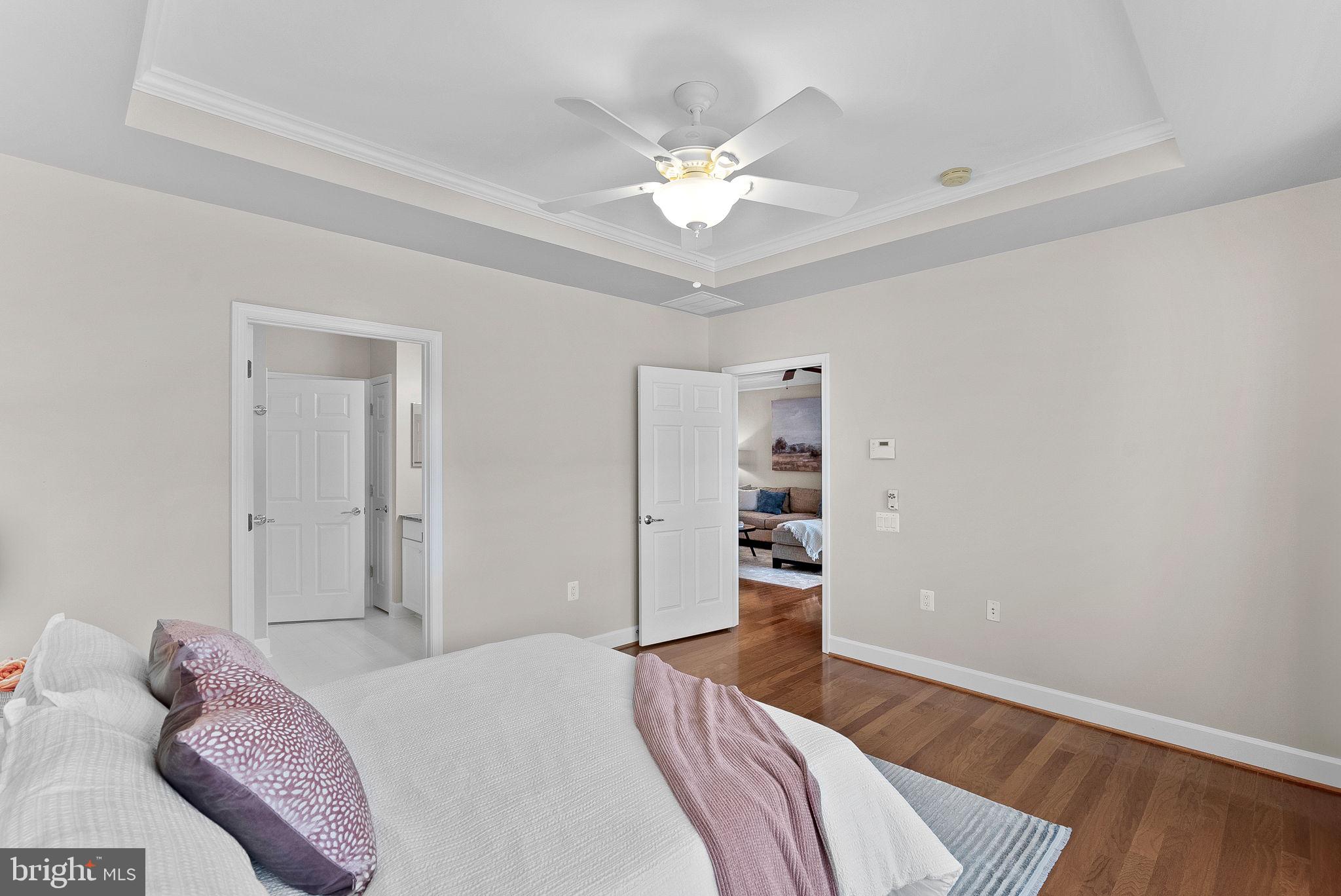 44424 Sunset Maple Drive Ashburn, VA 20147 - Photo 28 of 63 a bedroom with a bed and a chandelier