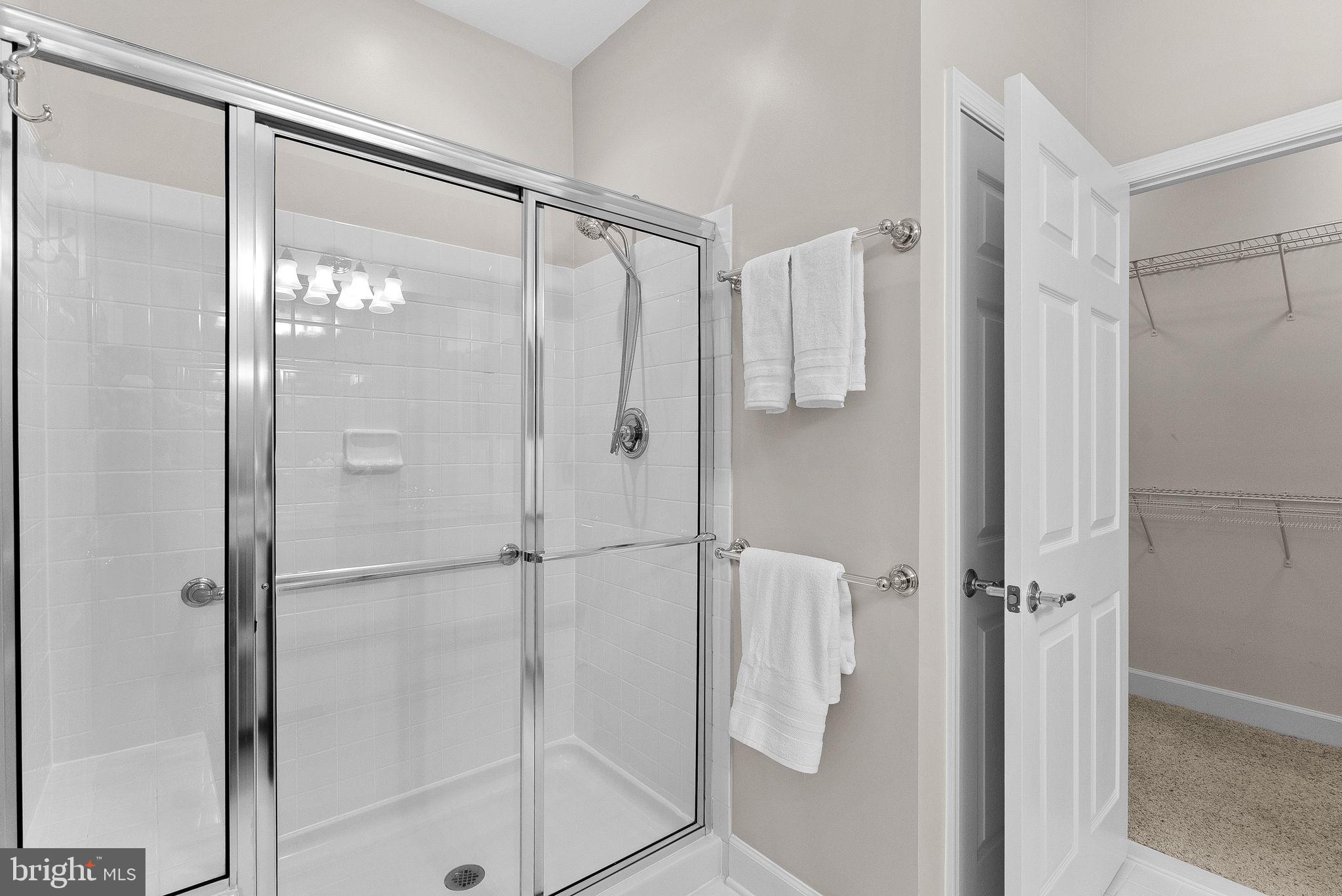 44424 Sunset Maple Drive Ashburn, VA 20147 - Photo 29 of 63 a bathroom with a glass shower door