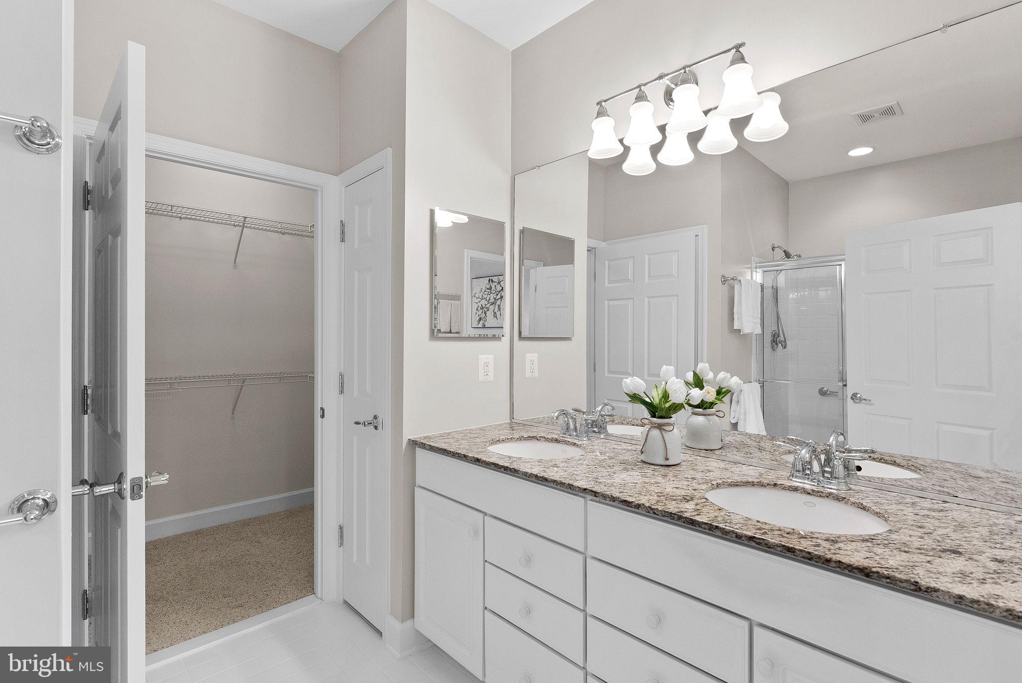 44424 Sunset Maple Drive Ashburn, VA 20147 - Photo 30 of 63 a bathroom with a granite countertop sink and a mirror