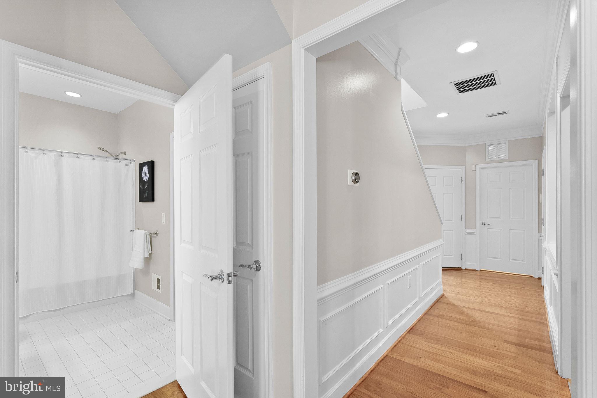 44424 Sunset Maple Drive Ashburn, VA 20147 - Photo 34 of 63 a view of a bathroom with a tub shower and hardwood floor