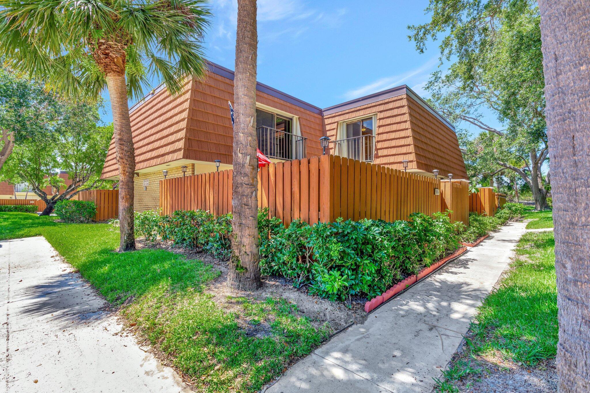 3016 30th Court Jupiter, FL 33477 - Photo 1 of 8 a front view of a house with garden