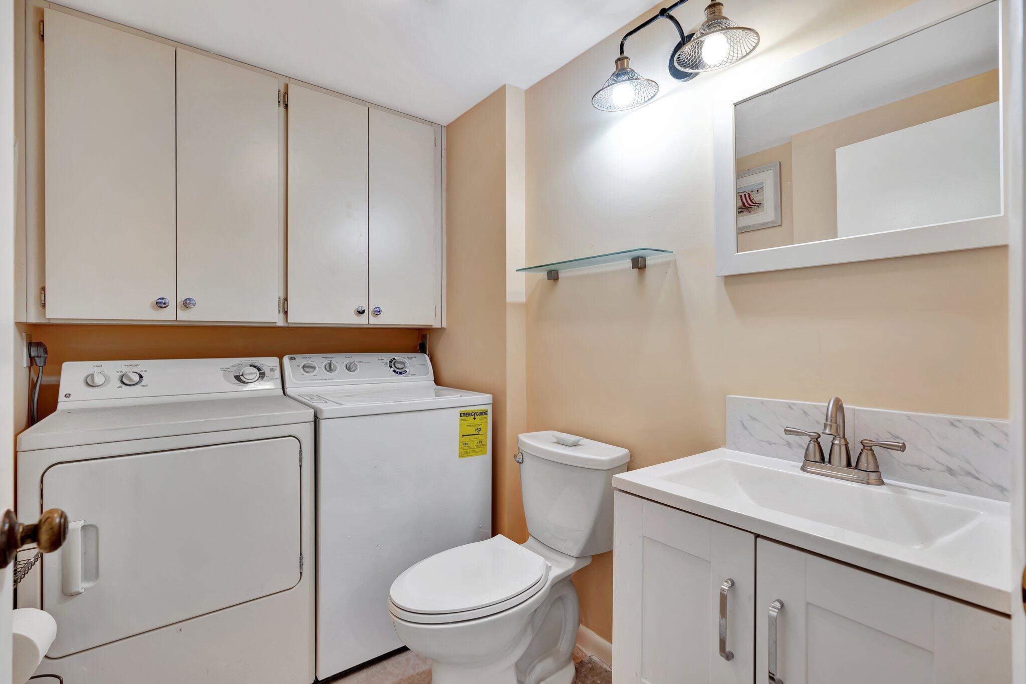 3016 30th Court Jupiter, FL 33477 - Photo 4 of 8 a view of bathroom with a washer and dryer