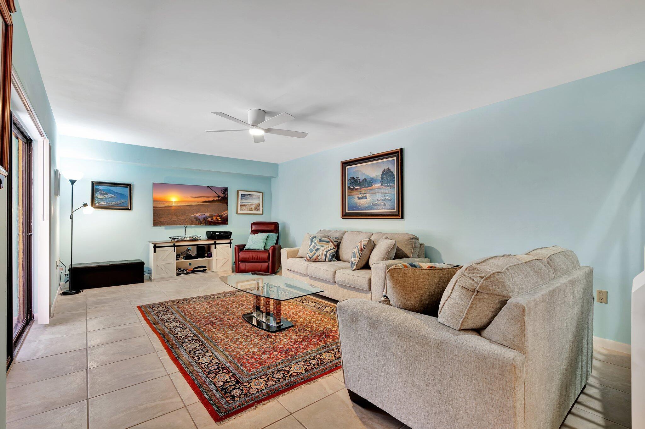 3016 30th Court Jupiter, FL 33477 - Photo 5 of 8 a living room with furniture and a flat screen tv