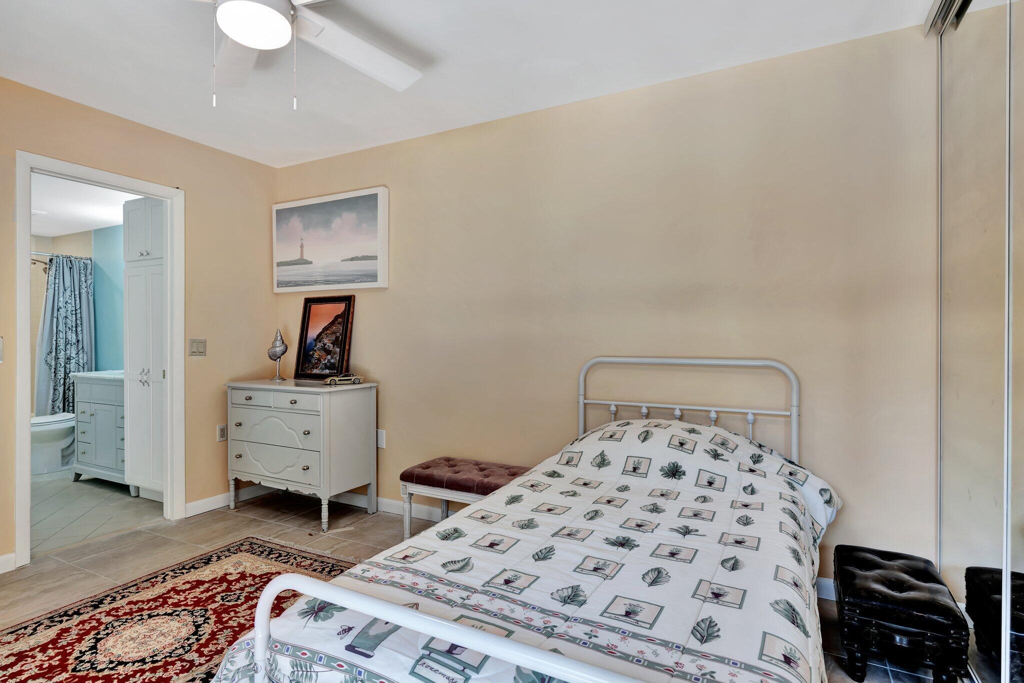 3016 30th Court Jupiter, FL 33477 - Photo 8 of 8 a bedroom with a bed and wooden floor
