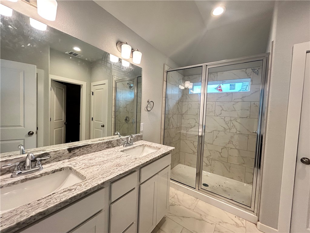 2791 Messenger Way Bryan, TX 77803 - Photo 6 of 15 a bathroom with a shower sink and mirror