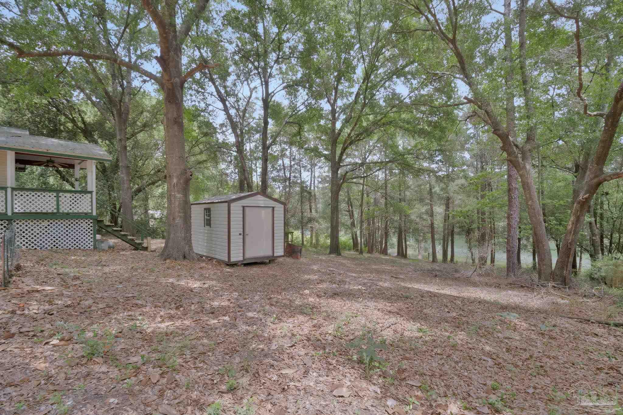 10290 West Lake Road Milton, FL 32583 - Photo 29 of 53 a view of a yard with large trees