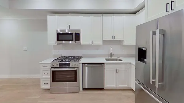 a kitchen with a stove and a refrigerator
