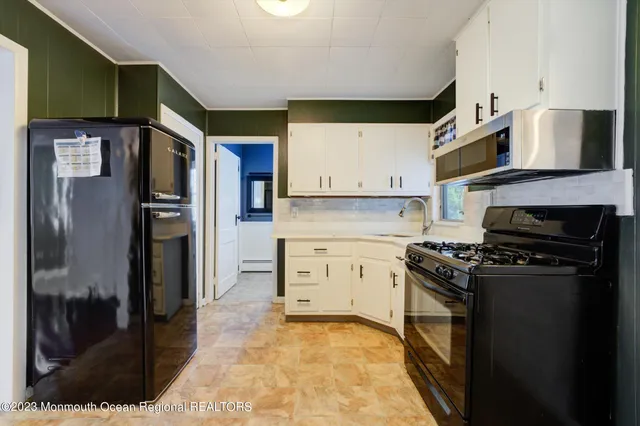a kitchen with stainless steel appliances granite countertop a refrigerator a stove and a sink