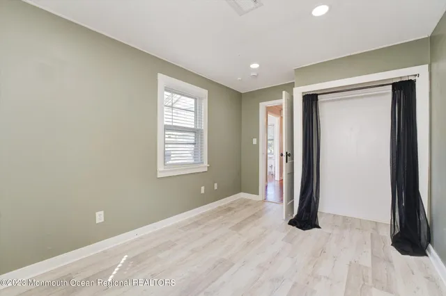 a view of a room with a large space and windows
