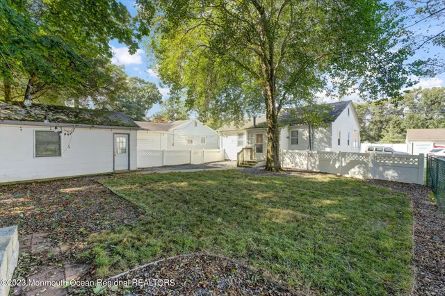 a view of backyard of house with green space