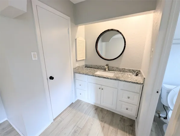 a white toilet sitting next to a bath tub