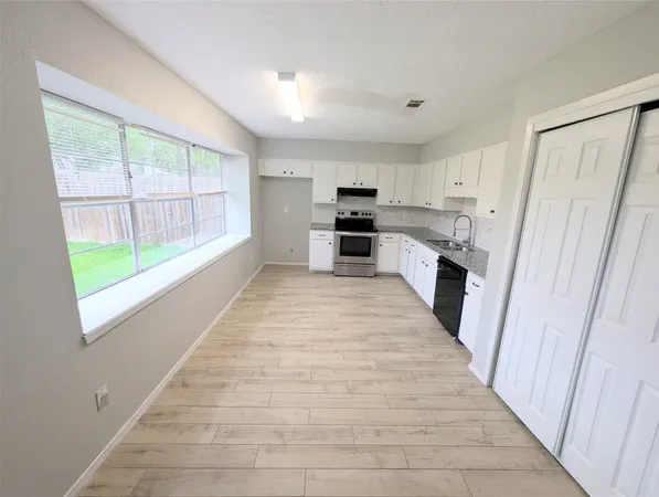 a view of a kitchen with a sink and dishwasher