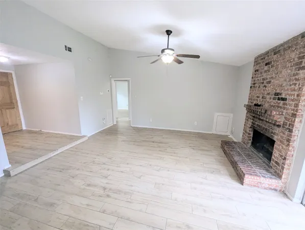 a view of empty room with a fireplace