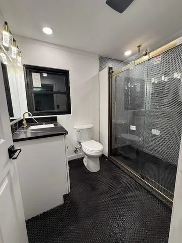 a bathroom with a toilet and a shower