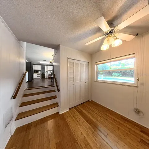 a view of entryway and hall with wooden floor