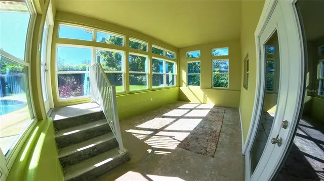 a view of a room with wooden floor and windows