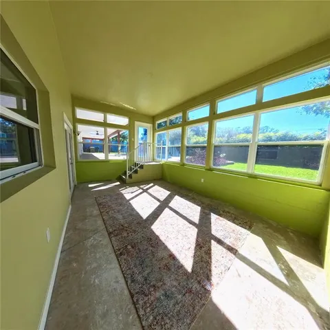 a living room with a bed furniture and a large window