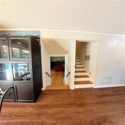a view of a livingroom with wooden floor and furniture