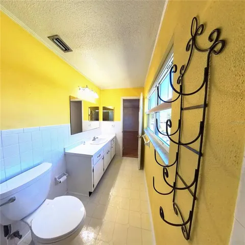 a bathroom with a sink mirror vanity and toilet