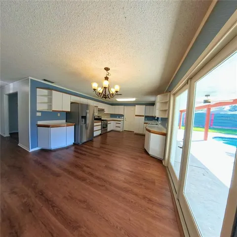 a view of a kitchen with a sink and cabinets