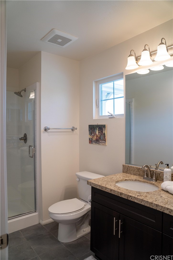110 Main Street Piru, CA 93040 - Photo 11 of 13 a bathroom with a granite countertop sink toilet and shower
