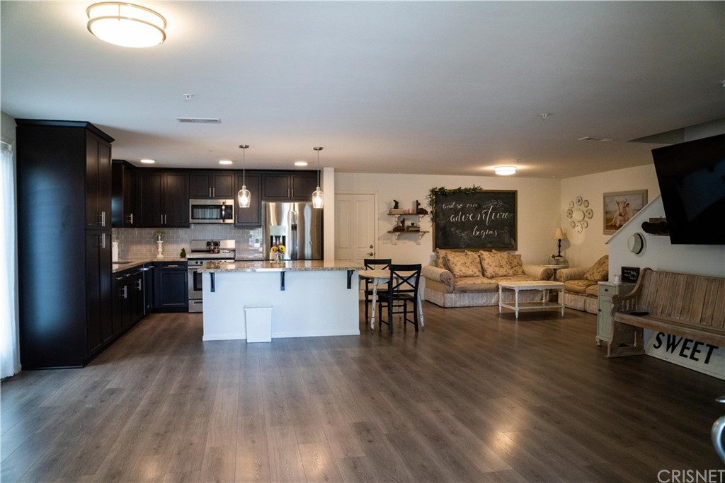 110 Main Street Piru, CA 93040 - Photo 2 of 13 a living room with stainless steel appliances furniture and a flat screen tv
