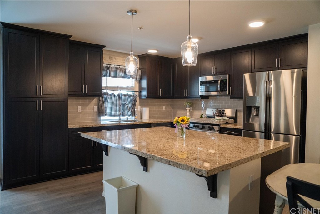 110 Main Street Piru, CA 93040 - Photo 4 of 13 a kitchen with a refrigerator a sink and a refrigerator