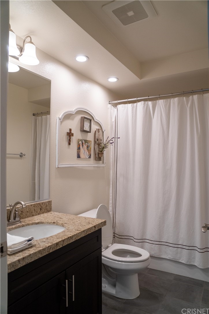 110 Main Street Piru, CA 93040 - Photo 6 of 13 a bathroom with a granite countertop sink and a toilet