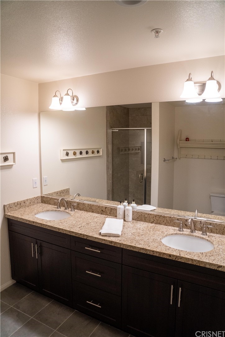 110 Main Street Piru, CA 93040 - Photo 9 of 13 a bathroom with a double vanity sink and a mirror