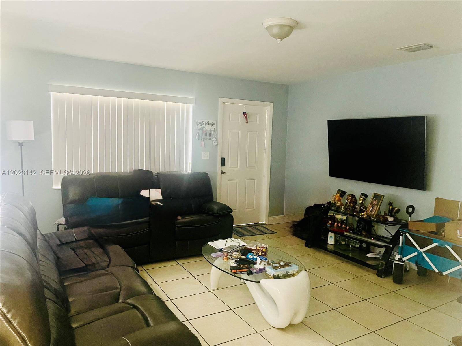 3410 Southwest 89th Court Miami, FL 33165 - Photo 6 of 18 a living room with furniture and a flat screen tv