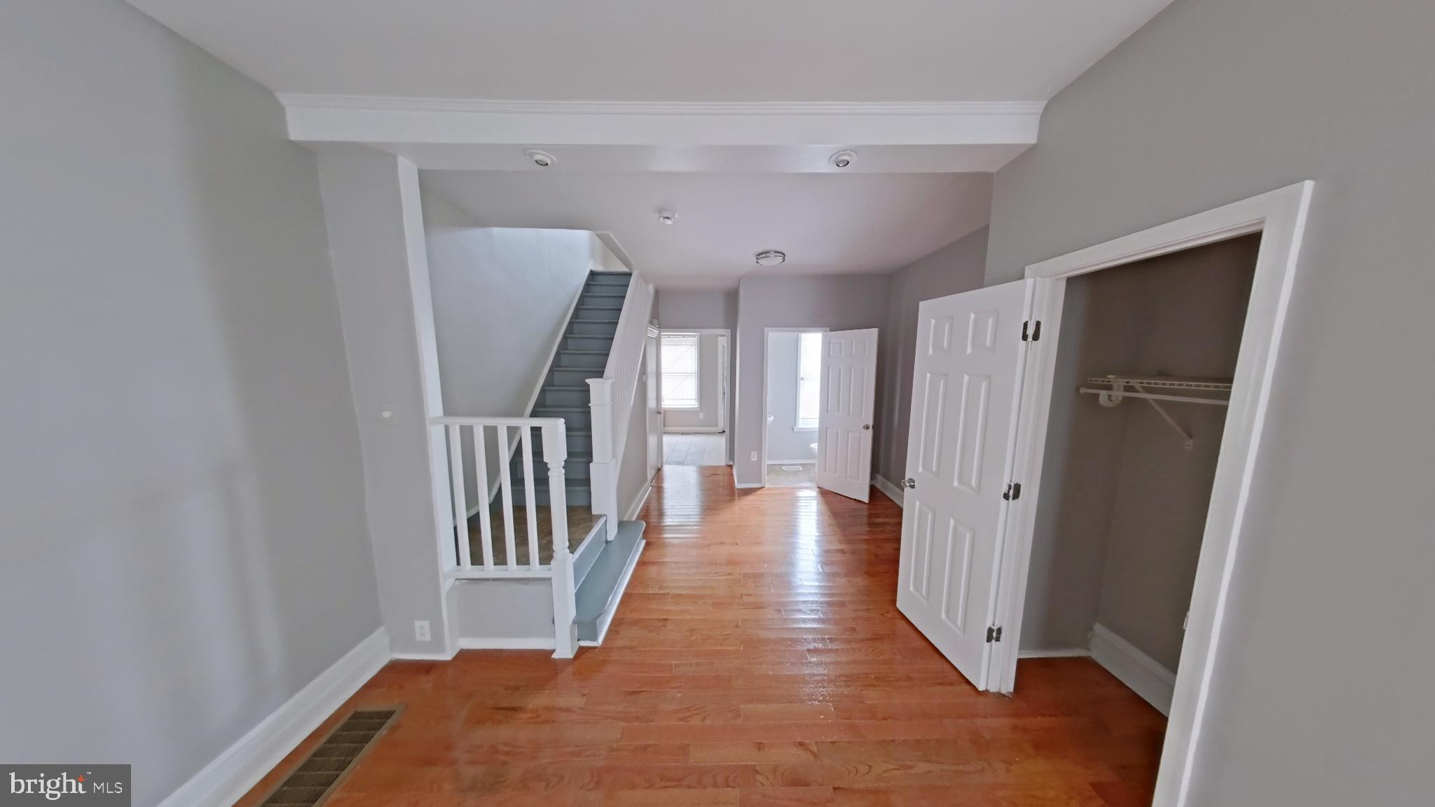 2255 North Cleveland Street Philadelphia, PA 19132 - Photo 3 of 9 a view of a hallway with wooden floor and staircase