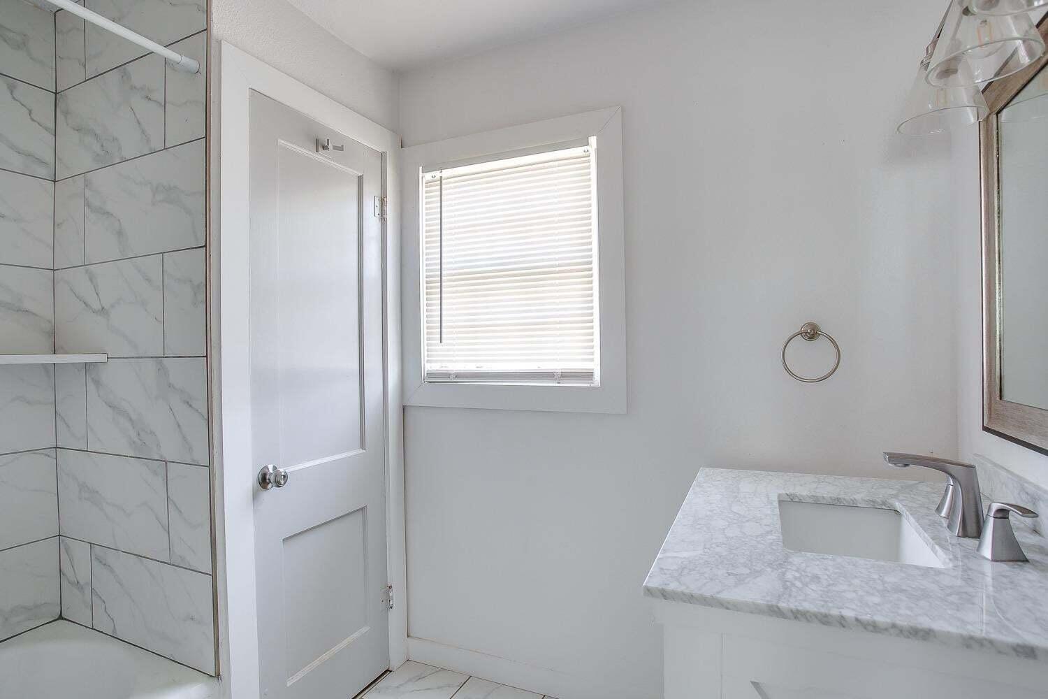 3414 24th Street Lubbock, TX 79410 - Photo 16 of 18 a bathroom with a sink and vanity