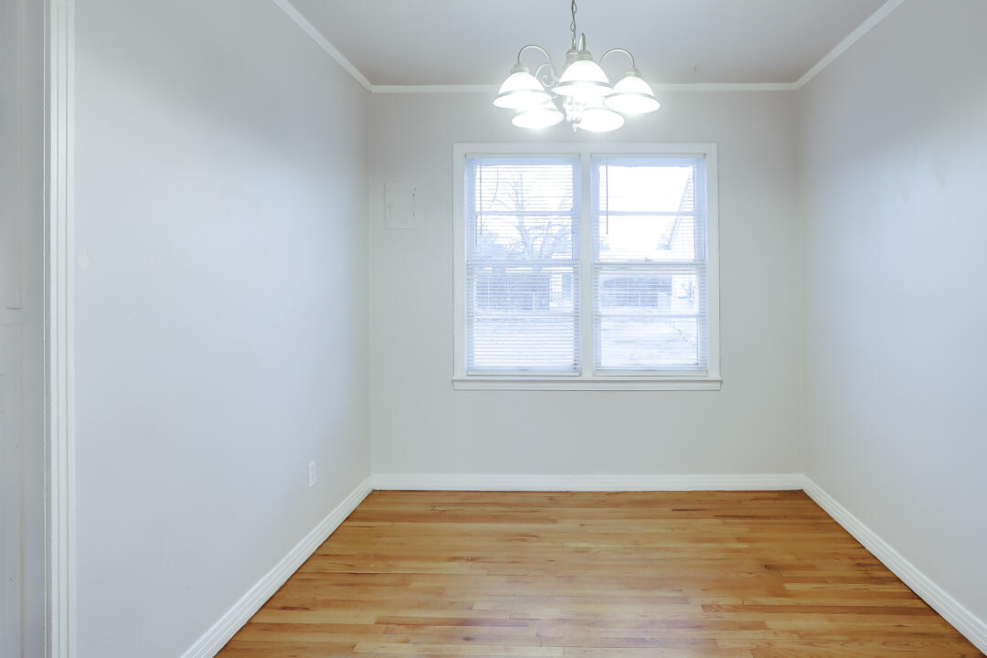 3414 24th Street Lubbock, TX 79410 - Photo 5 of 18 wooden floor in an empty room with a window