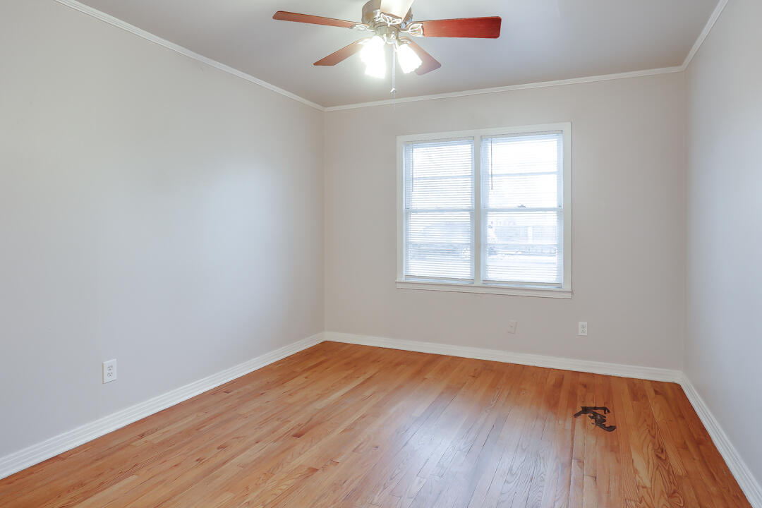 3414 24th Street Lubbock, TX 79410 - Photo 9 of 18 wooden floor in an empty room with a window