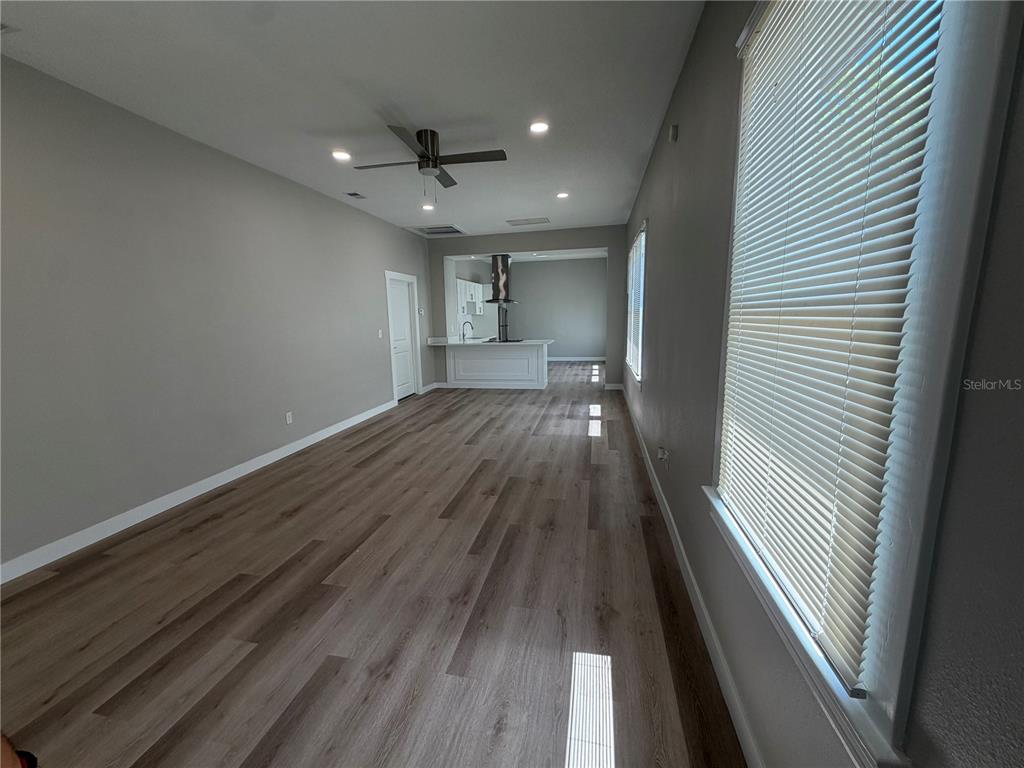 205 South 13th Street Palatka, FL 32177 - Photo 20 of 39 a view of a hallway with wooden floor and a ceiling fan