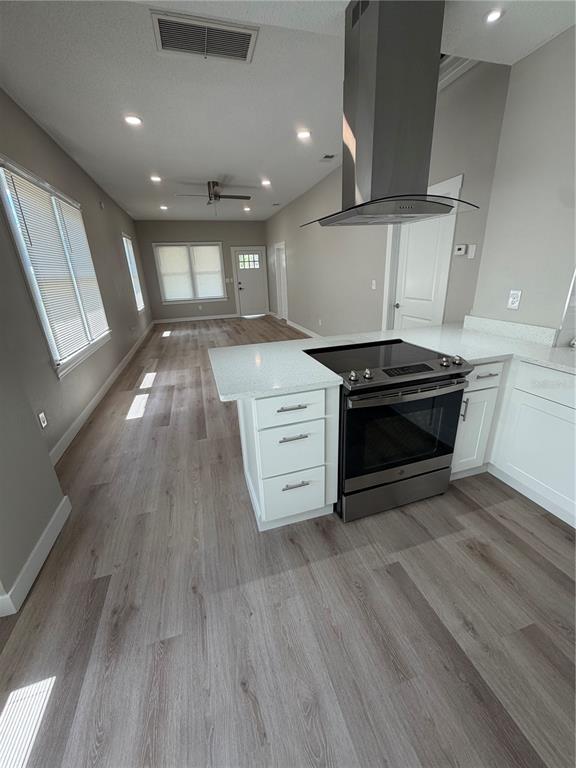 205 South 13th Street Palatka, FL 32177 - Photo 24 of 39 a view of a kitchen with a stove wooden cabinets and empty room