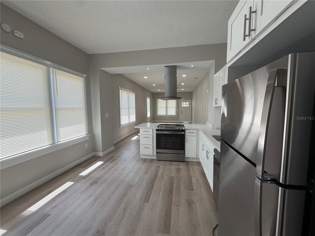 205 South 13th Street Palatka, FL 32177 - Photo 26 of 39 a kitchen with stainless steel appliances granite countertop a refrigerator a stove and a sink