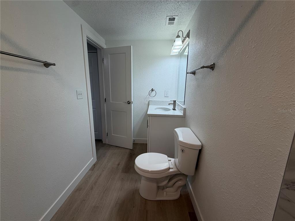 205 South 13th Street Palatka, FL 32177 - Photo 31 of 39 a white toilet sitting next to a wooden cabinet